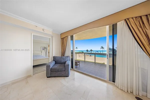 a living room with furniture and a floor to ceiling window