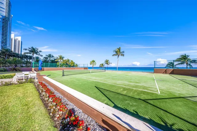a table with chairs and a potted plant