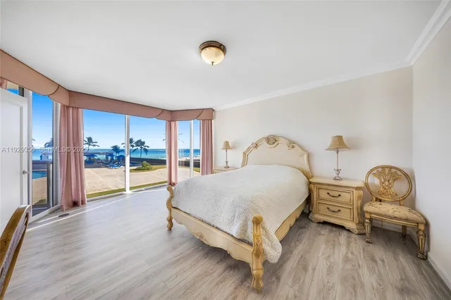 a spacious bedroom with a bed and large window