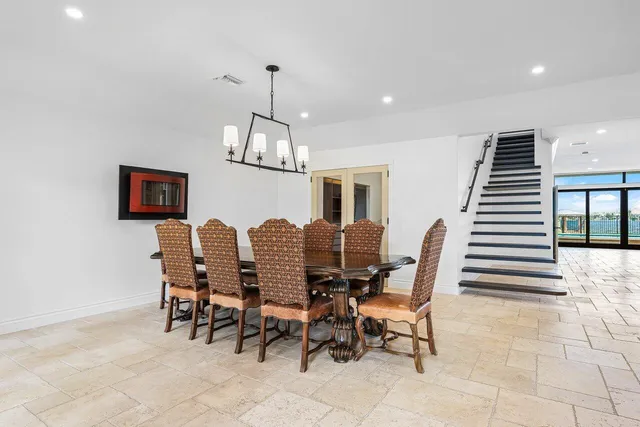 a large kitchen with stainless steel appliances kitchen island granite countertop a refrigerator and a sink