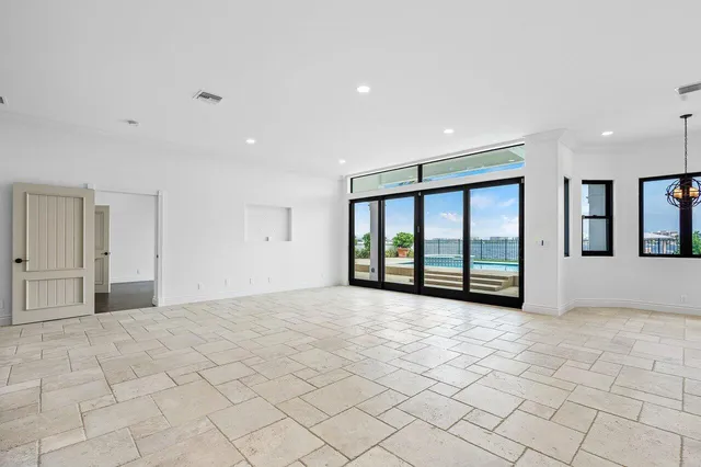 an empty room with wooden floor and cabinet