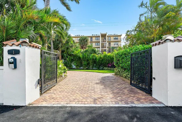 a view of a house with a yard and pathway