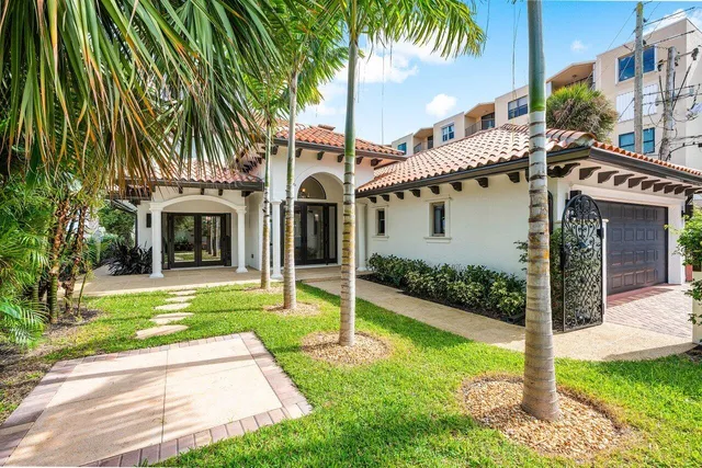 a view of a house with a yard and tree s