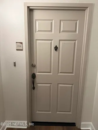 a kitchen with granite countertop a sink and a white cabinets