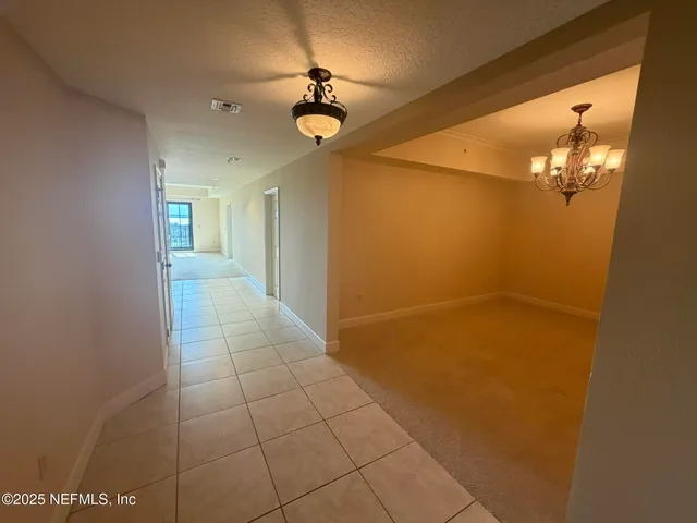 a large white kitchen with a refrigerator a counter top and oven