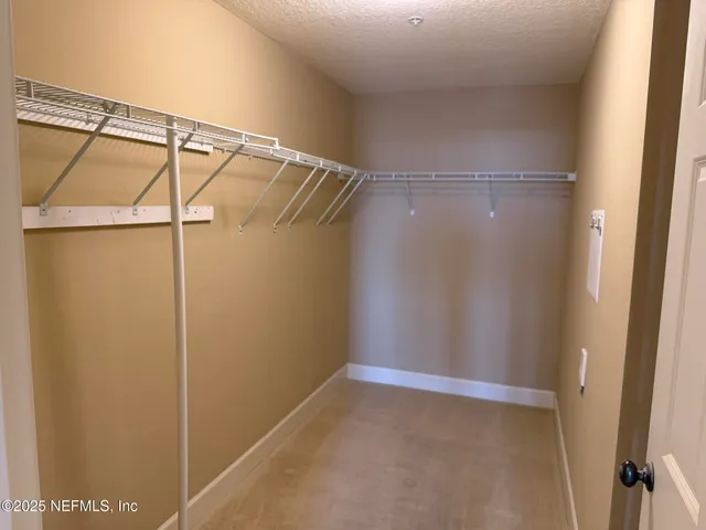 a view of a hallway with wooden floor and entryway