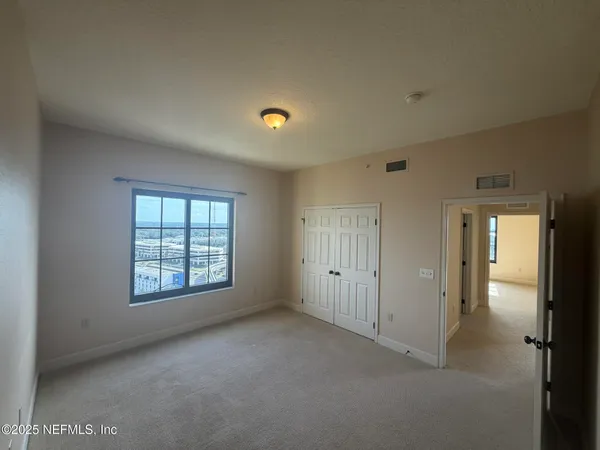 a living room with furniture and wall paintings