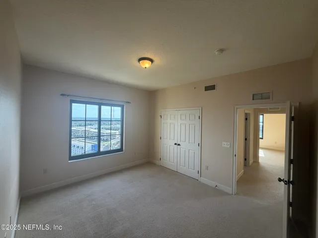 a living room with furniture and wall paintings