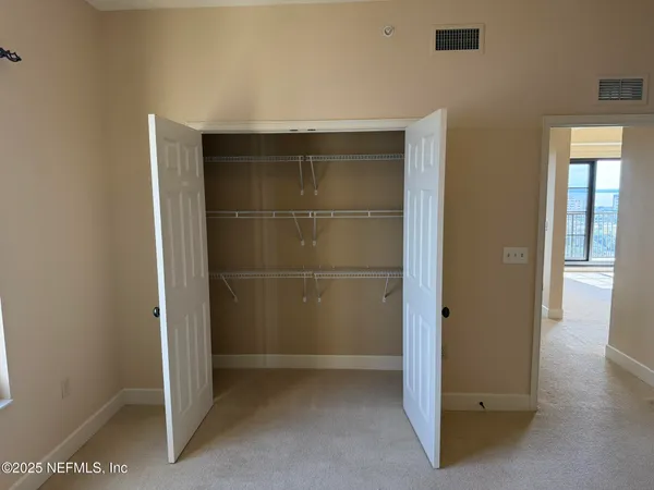 a view of a dining room with furniture and a window