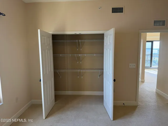 a view of a dining room with furniture and a window