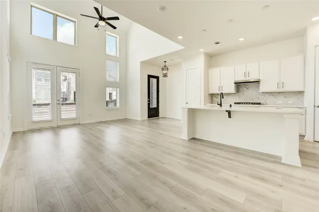 a view of a kitchen with a sink dishwasher a refrigerator and wooden cabinets