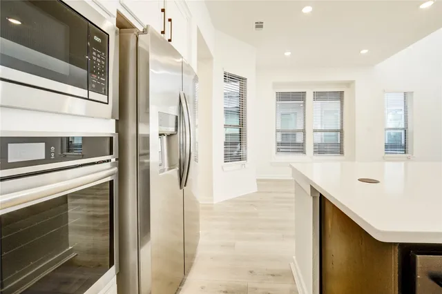 a hallway with windows and chandelier