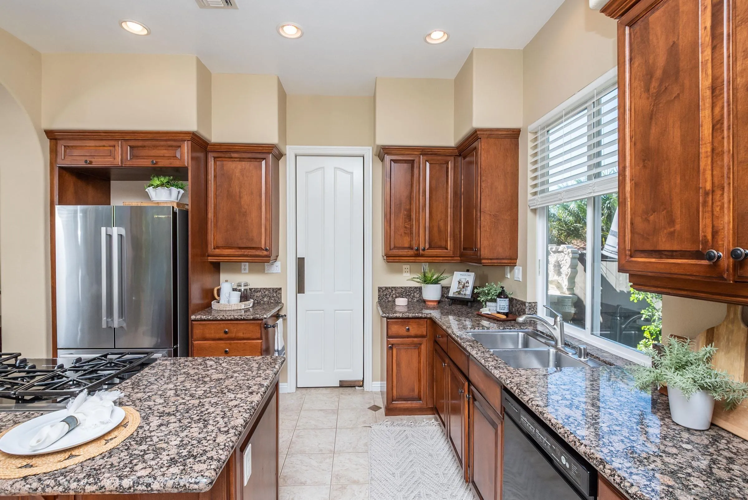 3008 Via Conquistador Carlsbad, CA 92009 - Photo 16 of 31 a kitchen with stainless steel appliances granite countertop a sink a stove and a refrigerator