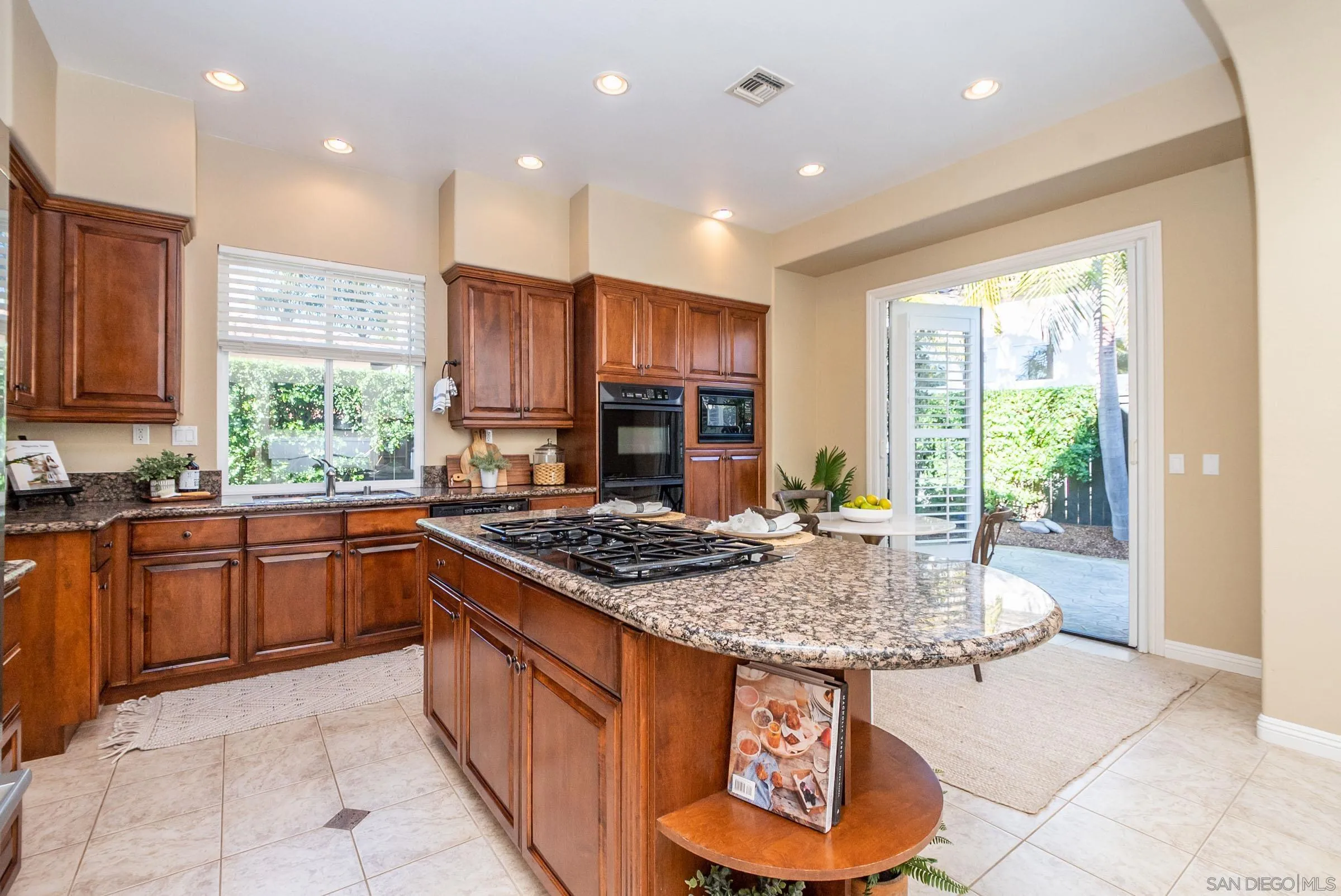 3008 Via Conquistador Carlsbad, CA 92009 - Photo 17 of 31 a kitchen with stainless steel appliances granite countertop a stove a sink dishwasher and a refrigerator