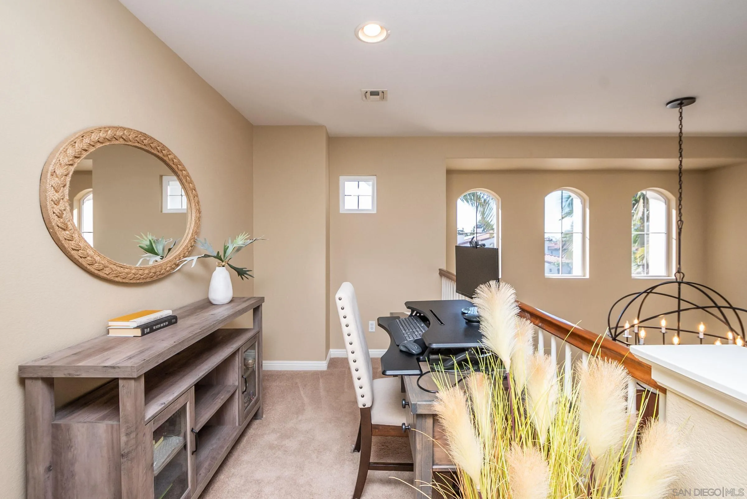 3008 Via Conquistador Carlsbad, CA 92009 - Photo 29 of 31 a living room with furniture a mirror and a stove