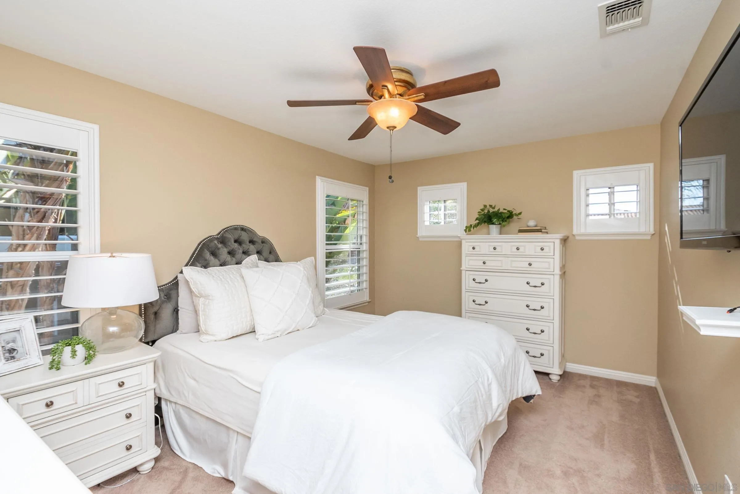3008 Via Conquistador Carlsbad, CA 92009 - Photo 30 of 31 a bedroom with a bed and a chandelier