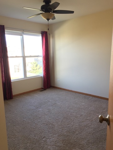 562 Wynbrooke Road Romeoville, IL 60446 - Photo 15 of 24 an empty room with a window and a fan