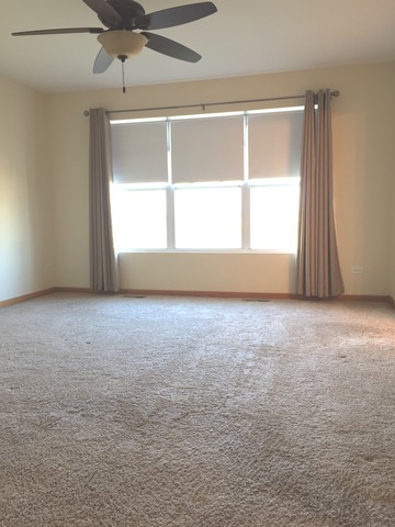 562 Wynbrooke Road Romeoville, IL 60446 - Photo 18 of 24 an empty room with a window and ceiling fan