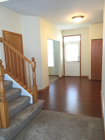 562 Wynbrooke Road Romeoville, IL 60446 - Photo 3 of 24 a view of entryway and hall with wooden floor