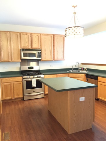 562 Wynbrooke Road Romeoville, IL 60446 - Photo 8 of 24 a kitchen with stainless steel appliances a stove a sink and a microwave