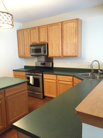 562 Wynbrooke Road Romeoville, IL 60446 - Photo 10 of 24 a kitchen with stainless steel appliances granite countertop a sink a stove and a refrigerator