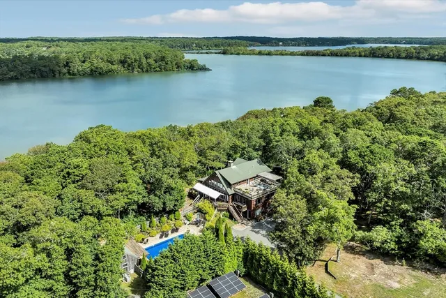 an aerial view of a houses with a lake view