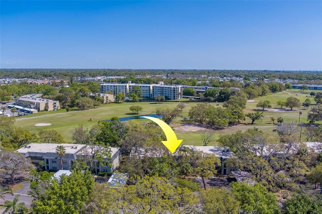68 Country Club Drive Largo, FL 33771 - Photo 16 of 19 a view of a lake with houses in the back