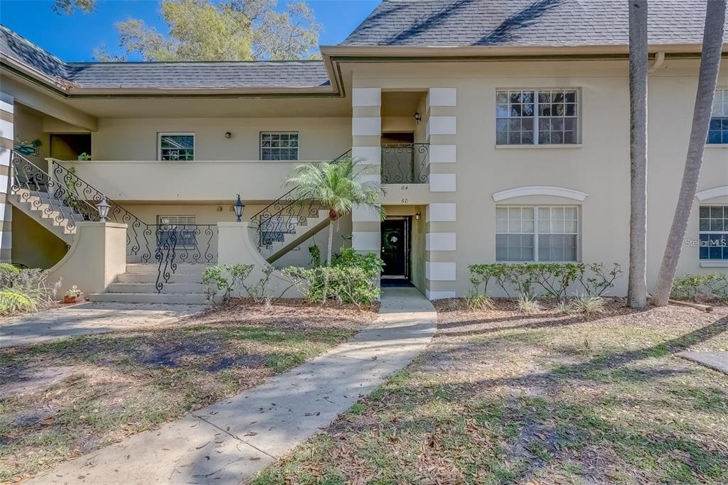 68 Country Club Drive Largo, FL 33771 - Photo 17 of 19 a front view of a house with a yard