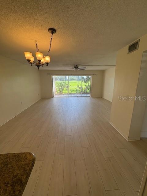 68 Country Club Drive Largo, FL 33771 - Photo 3 of 19 an empty room with wooden floor and windows