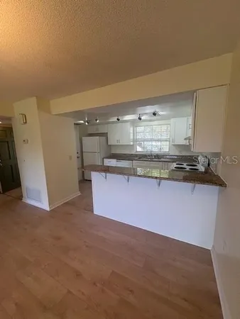 a kitchen with stainless steel appliances granite countertop a sink and cabinets