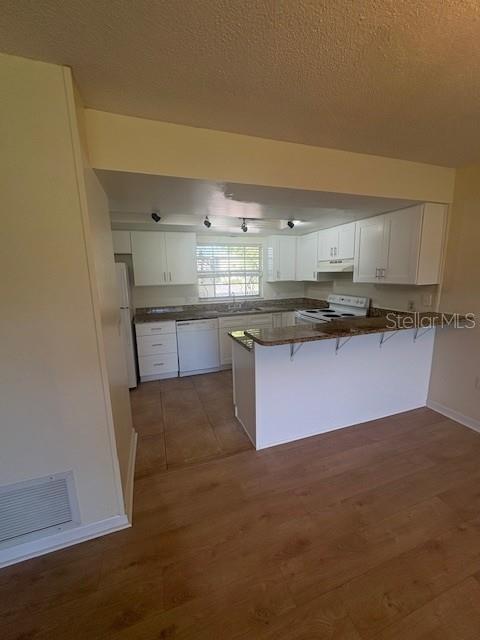 68 Country Club Drive Largo, FL 33771 - Photo 5 of 19 a kitchen with stainless steel appliances granite countertop a sink and cabinets
