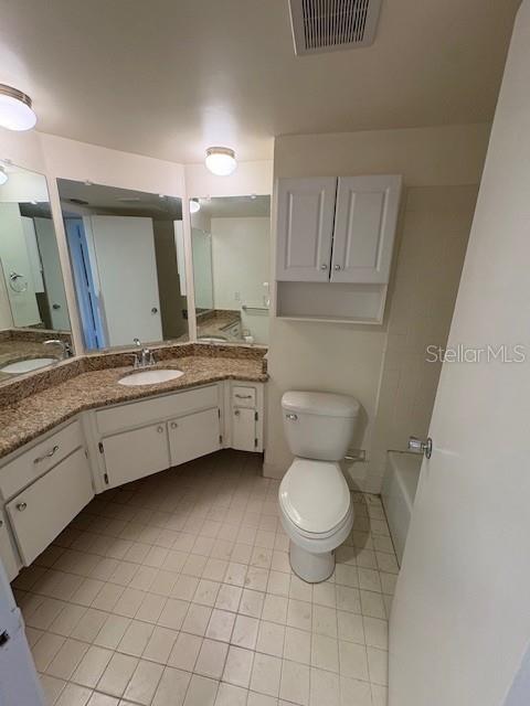 68 Country Club Drive Largo, FL 33771 - Photo 7 of 19 a bathroom with a toilet sink and mirror