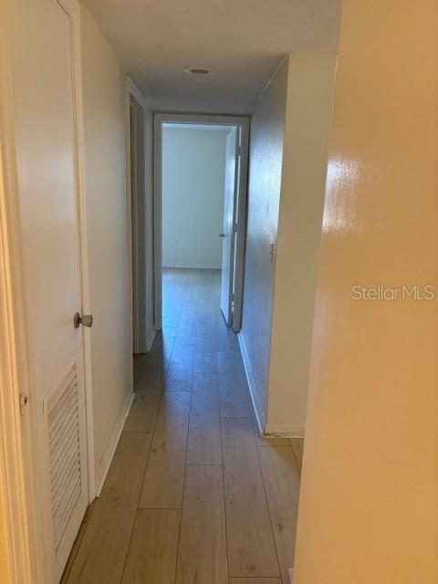 68 Country Club Drive Largo, FL 33771 - Photo 9 of 19 a view of a hallway with wooden floor