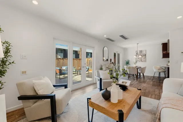 a living room with furniture and a potted plant