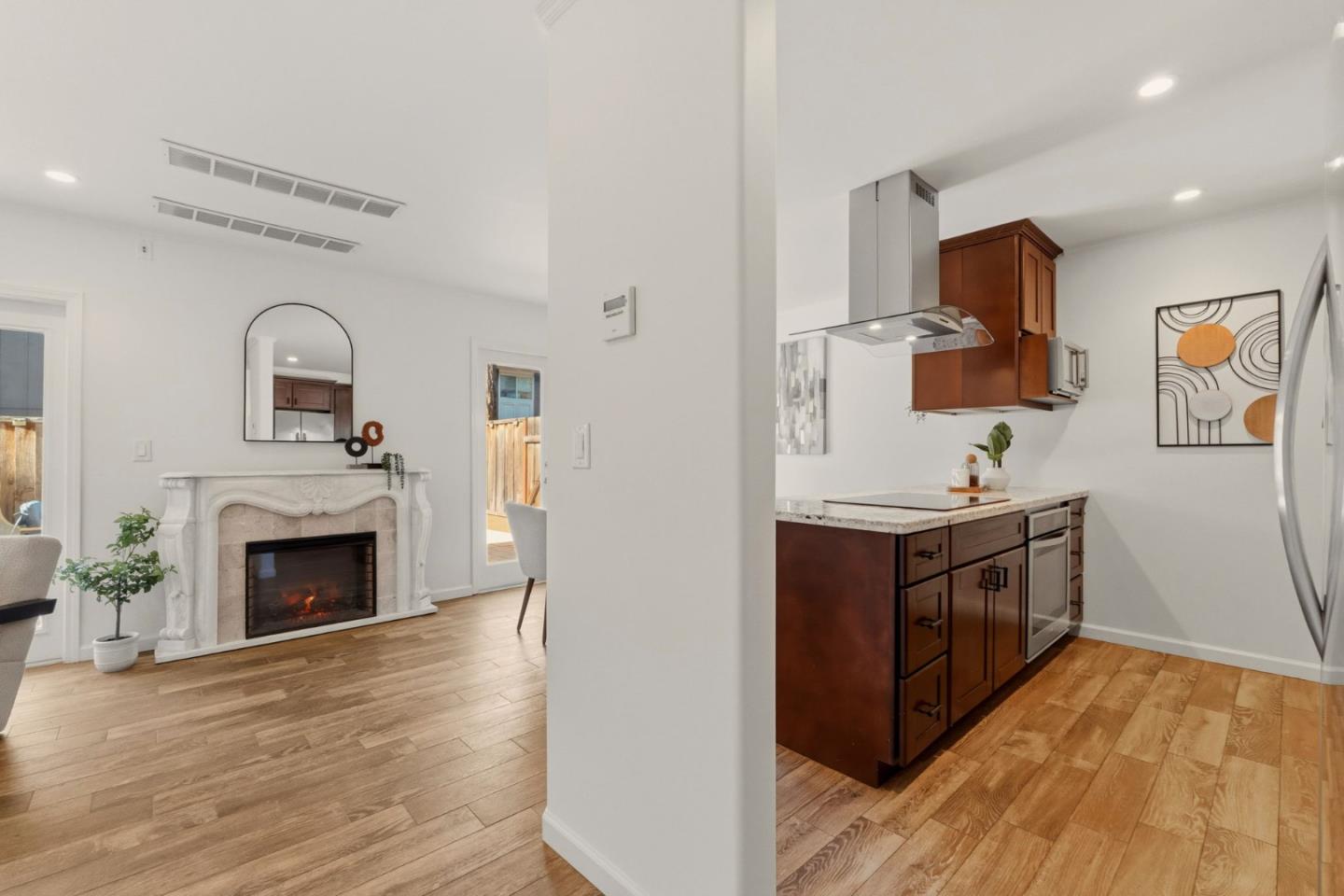 104 East Middlefield Road, Unit B Mountain View, CA 94043 - Photo 15 of 48 a large kitchen with stainless steel appliances granite countertop a stove top oven a sink with wooden floors