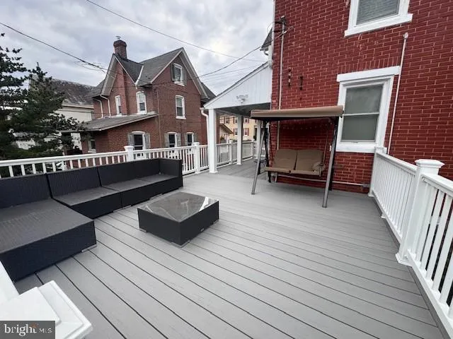 a view of couches on the deck with wooden floor