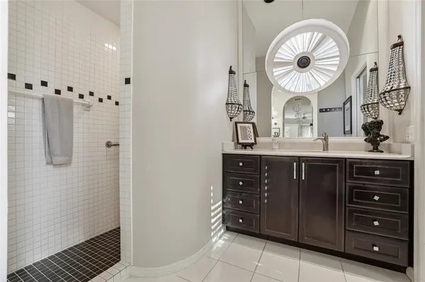 a bathroom with a granite countertop sink a toilet and a shower