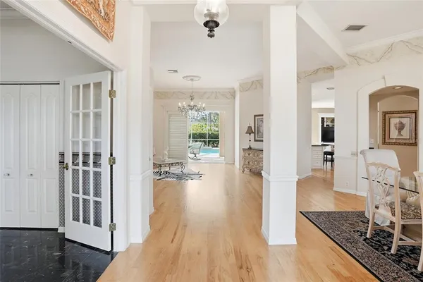 a living room with furniture and a chandelier