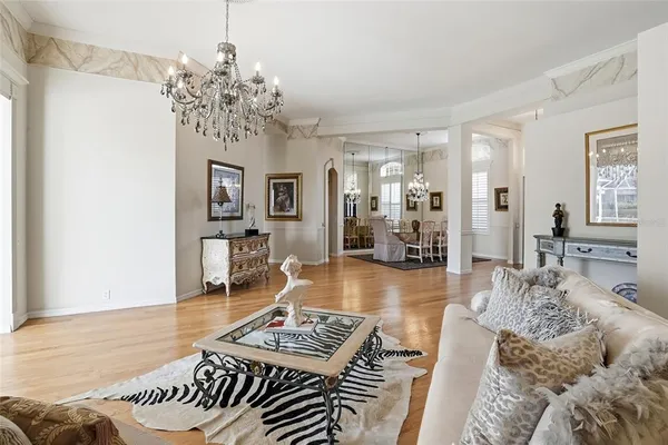 a view of a dining room with furniture and chandelier