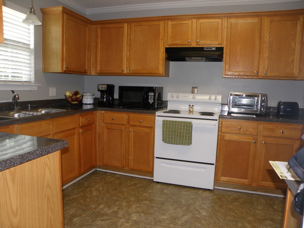 3375 Trotter''s Ridge Gray, GA 31032 - Photo 3 of 13 a kitchen with granite countertop a sink stove and cabinets