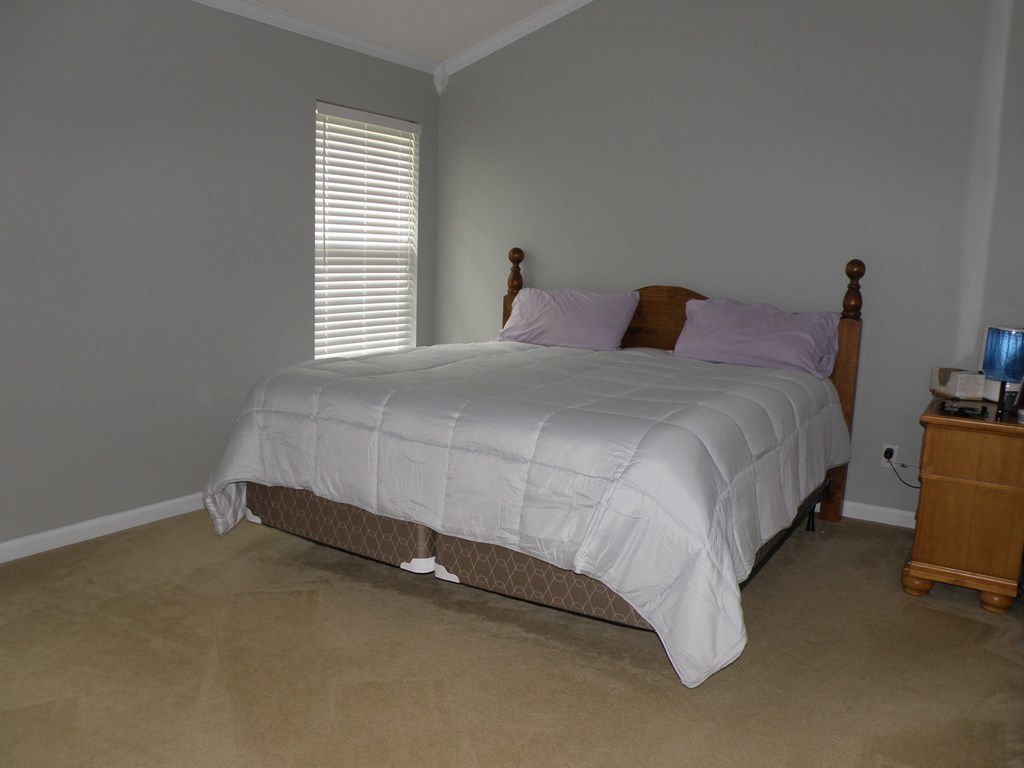 3375 Trotter''s Ridge Gray, GA 31032 - Photo 8 of 13 a bed sitting in a bedroom next to a window