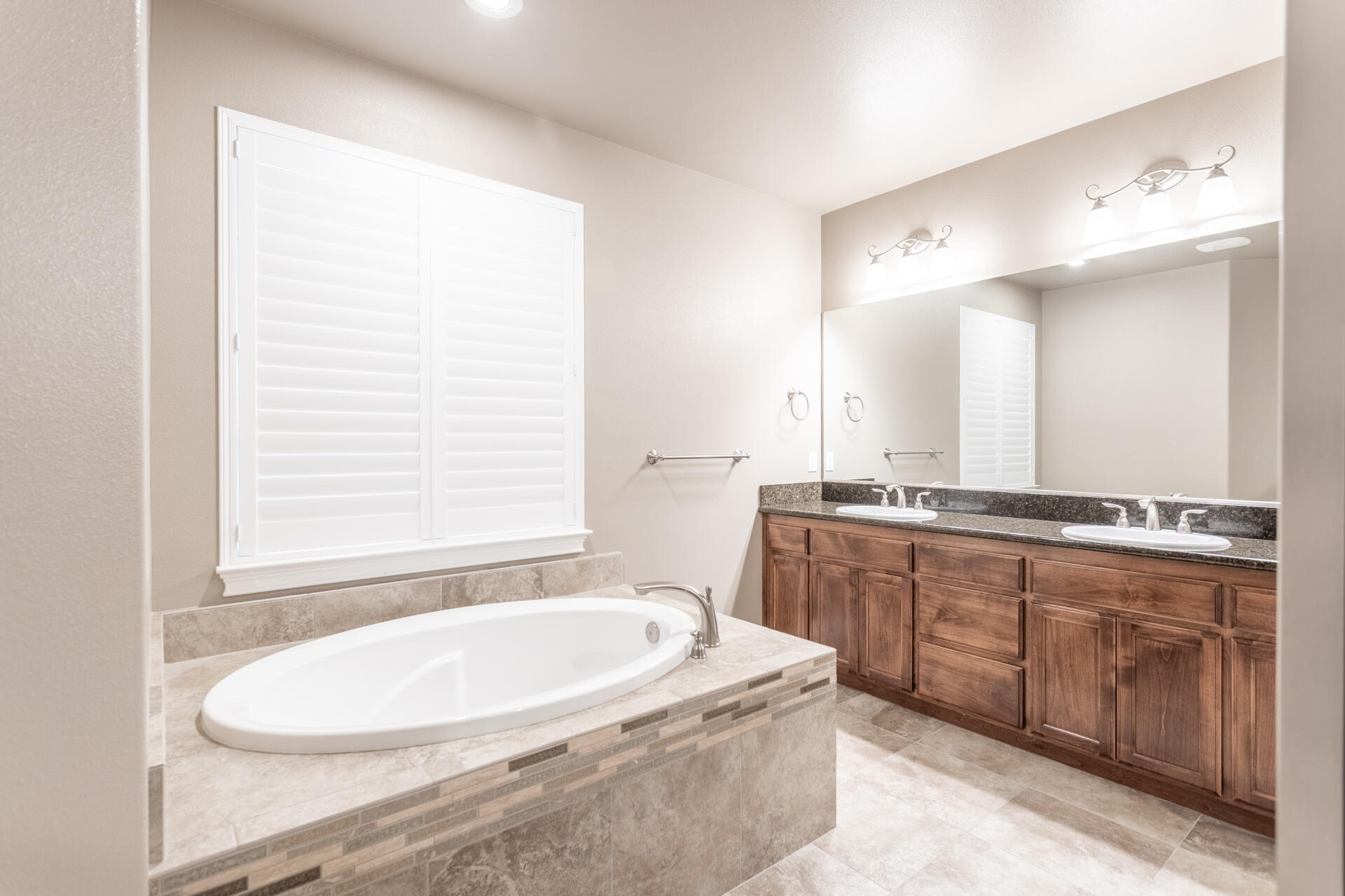 3241 Lemurian Road Redding, CA 96002 - Photo 16 of 34 a bathroom with a granite countertop sink and a bathtub