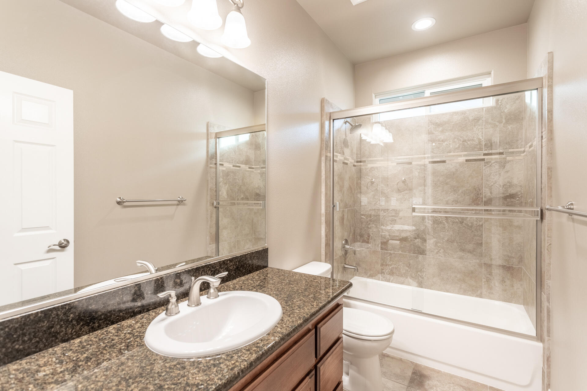 3241 Lemurian Road Redding, CA 96002 - Photo 22 of 34 a bathroom with a granite countertop sink toilet and shower