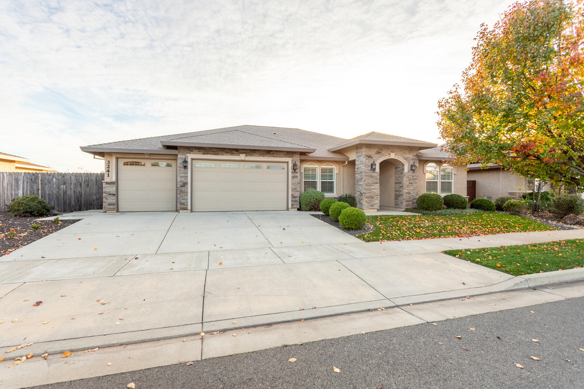 3241 Lemurian Road Redding, CA 96002 - Photo 34 of 34 a view of white house with a yard and potted plants