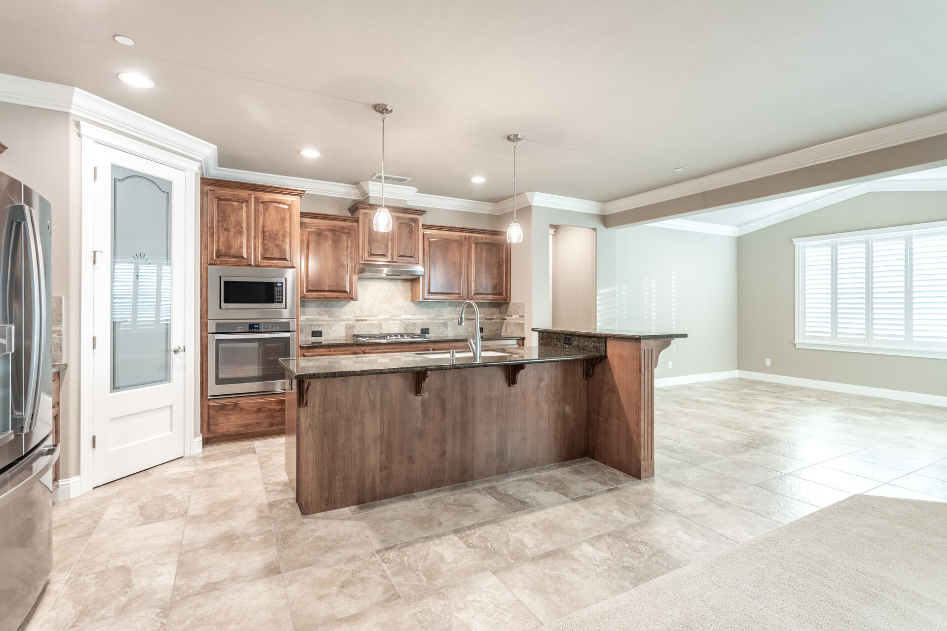 3241 Lemurian Road Redding, CA 96002 - Photo 7 of 34 a kitchen with stainless steel appliances granite countertop a refrigerator and a sink