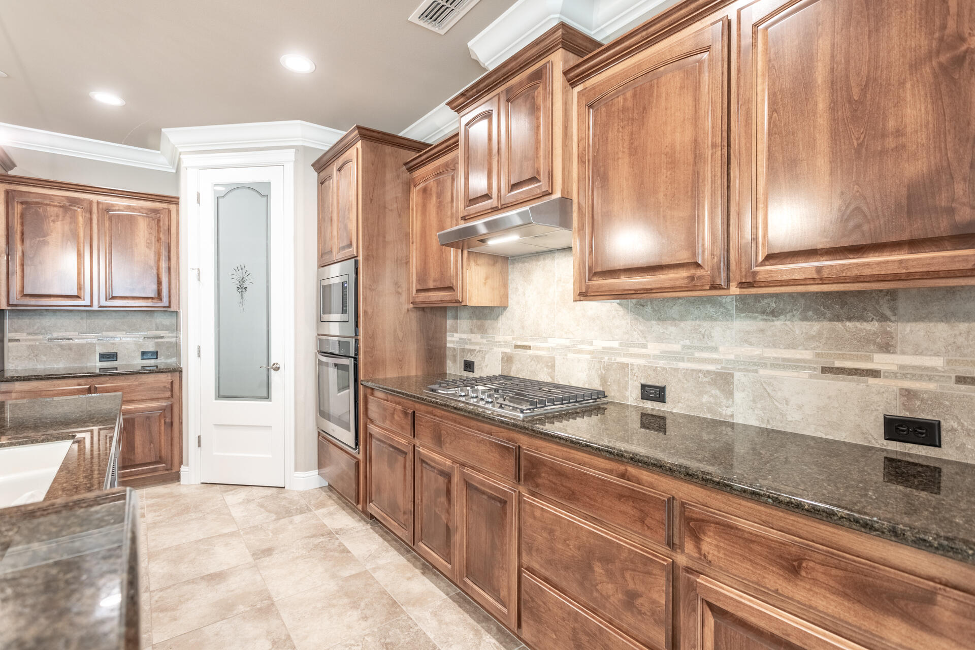 3241 Lemurian Road Redding, CA 96002 - Photo 8 of 34 a kitchen with stainless steel appliances granite countertop a refrigerator and a stove top oven