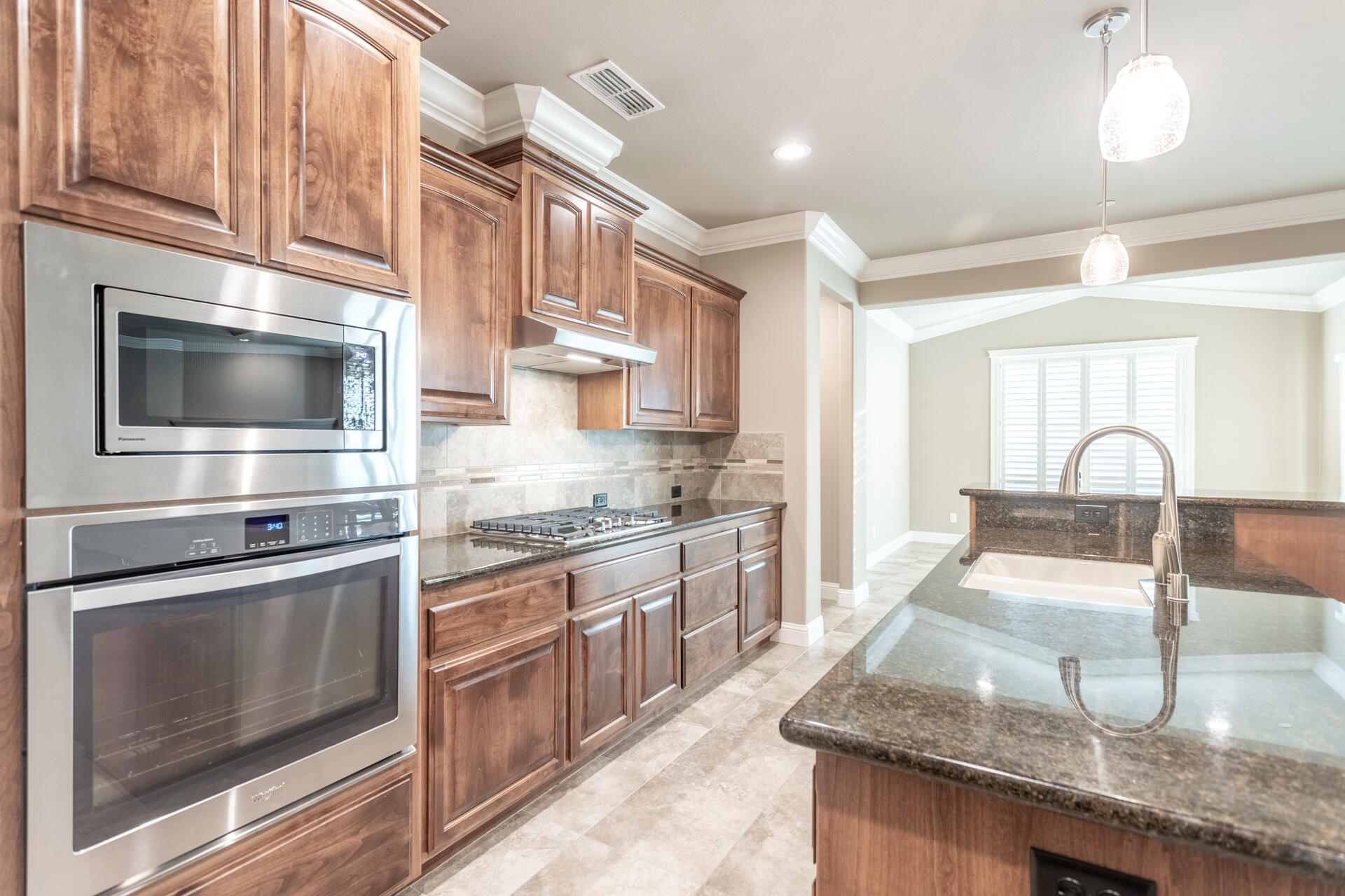 3241 Lemurian Road Redding, CA 96002 - Photo 9 of 34 a kitchen with stainless steel appliances granite countertop a sink and a stove