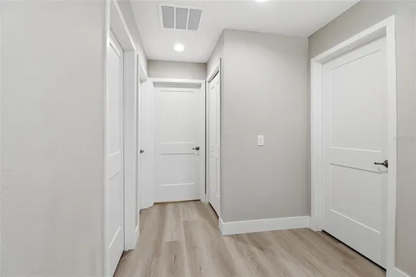 a view of hallway with wooden floor