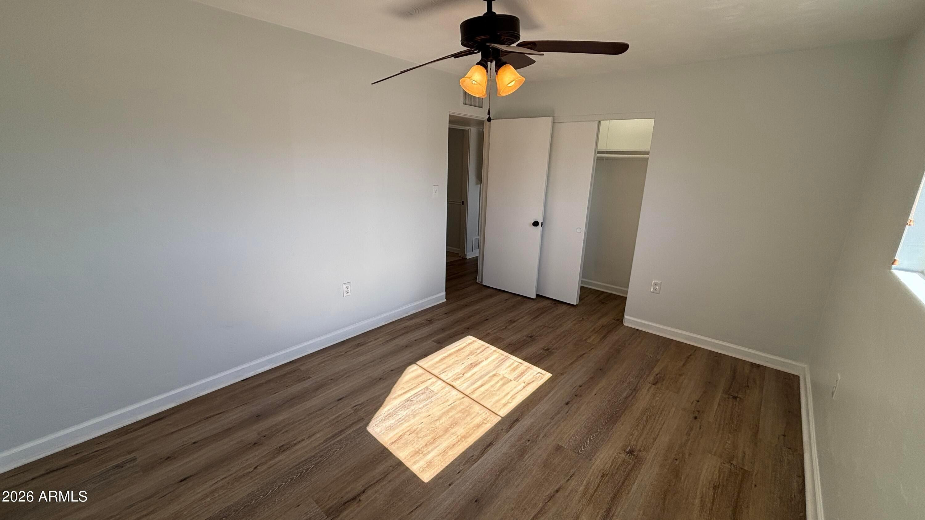 1000 West Elna Rae Street Tempe, AZ 85281 - Photo 14 of 22 wooden floor in an empty room with a window