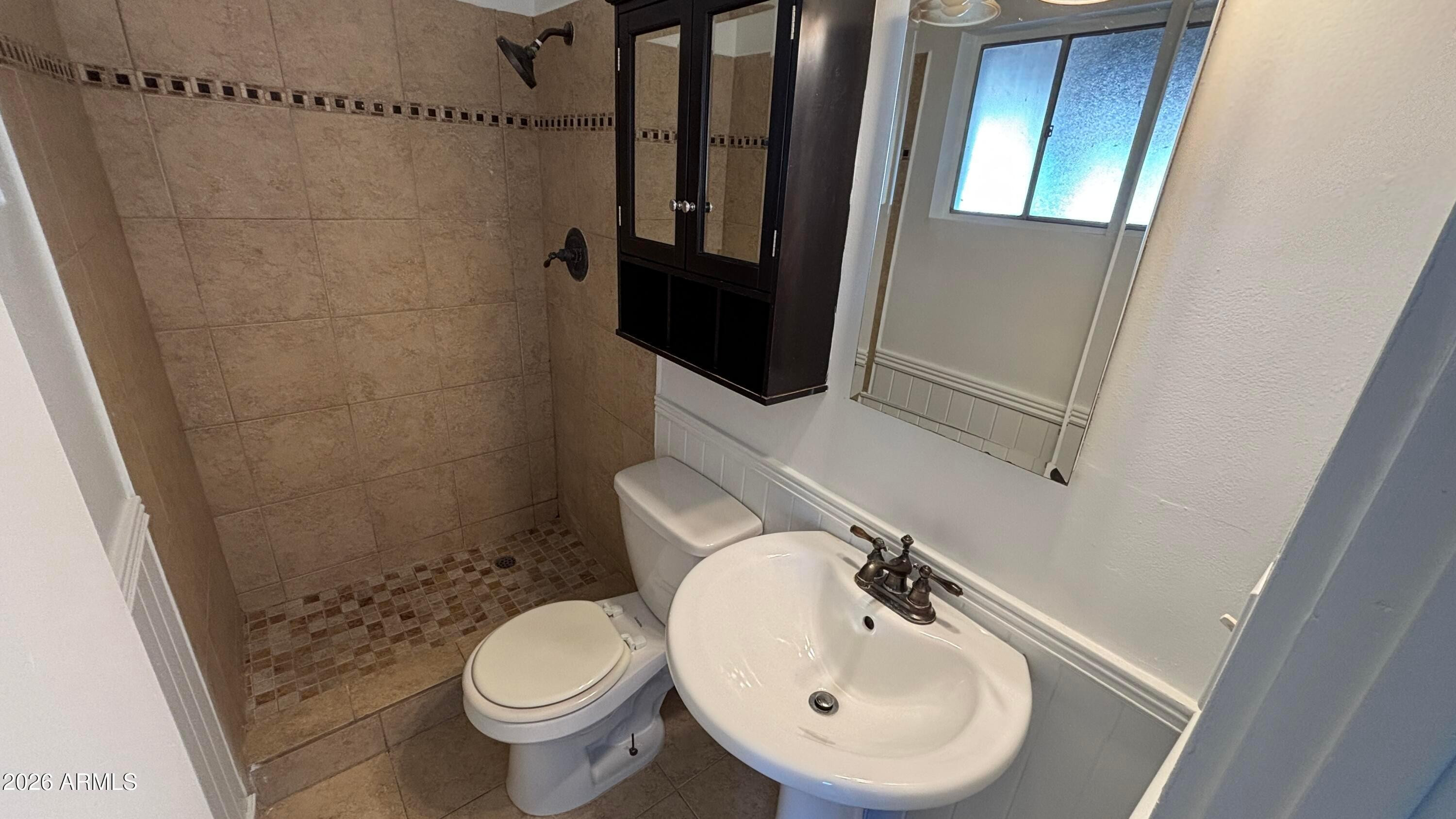 1000 West Elna Rae Street Tempe, AZ 85281 - Photo 19 of 22 a bathroom with a sink a toilet and shower